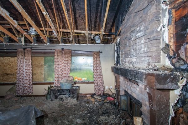 Fire-damaged fireplace before restoration